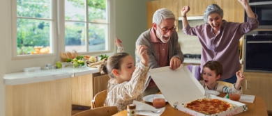 Grandparents eating pizza with their grand kids